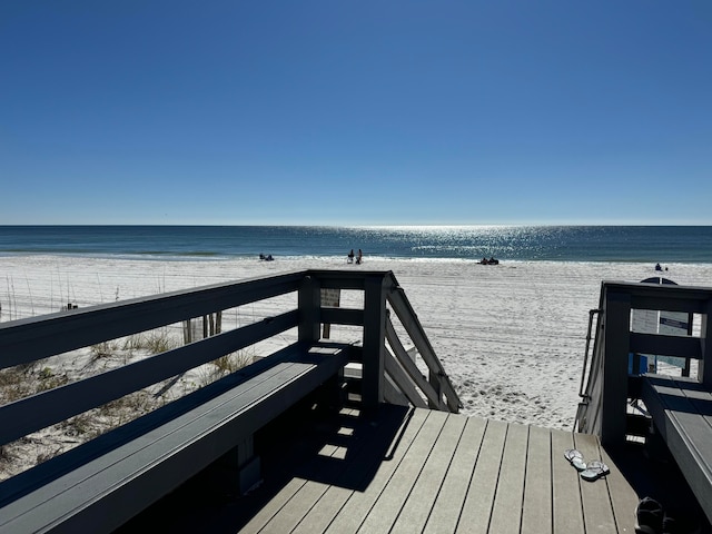 view of community with a water view and a view of the beach