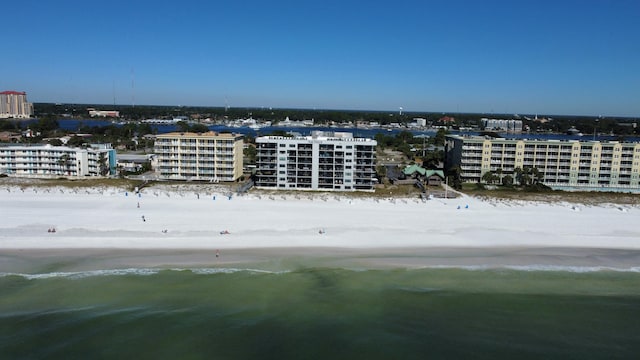 birds eye view of property with a water view and a view of the beach