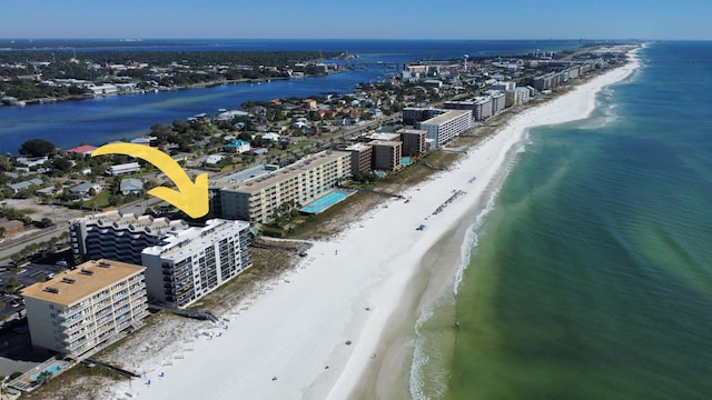 birds eye view of property featuring a beach view and a water view