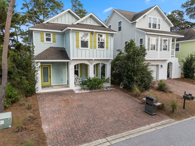 view of front of house featuring a porch and a garage