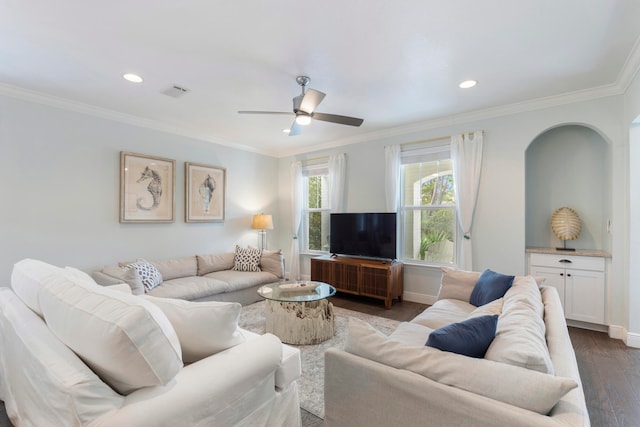 living room with dark hardwood / wood-style flooring, ceiling fan, and crown molding