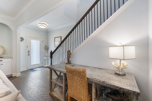 foyer entrance featuring dark hardwood / wood-style floors and ornamental molding