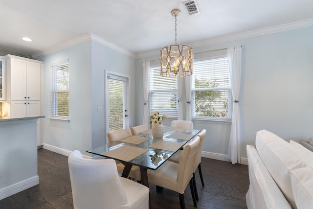 dining room featuring a chandelier, plenty of natural light, dark wood-type flooring, and ornamental molding