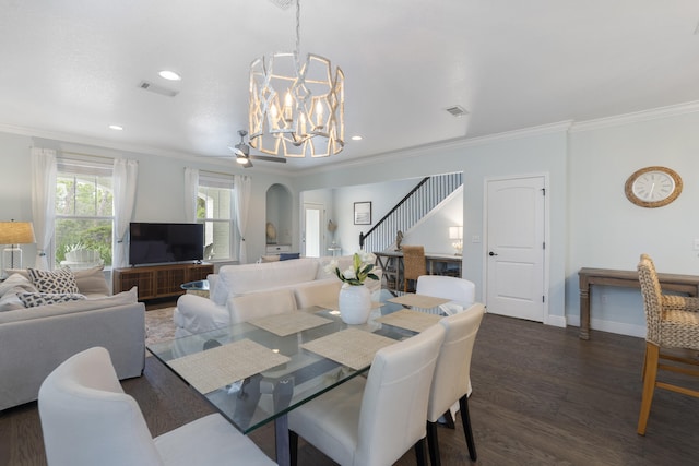 dining area featuring an inviting chandelier, crown molding, and dark wood-type flooring