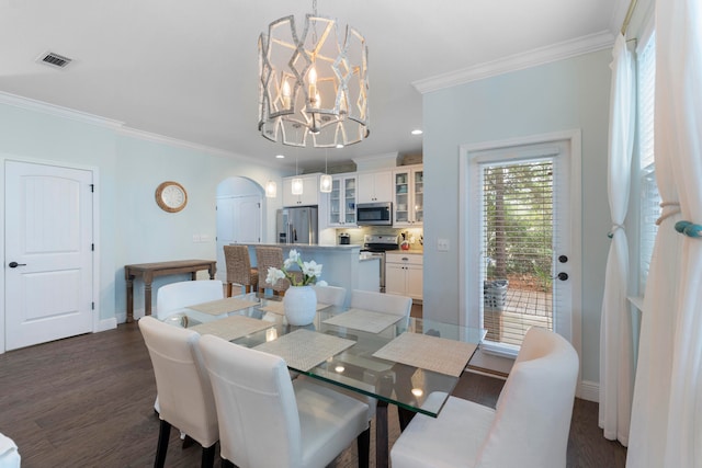 dining room with a chandelier, crown molding, and dark hardwood / wood-style flooring