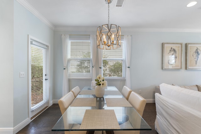 dining room with a chandelier, dark hardwood / wood-style flooring, and crown molding