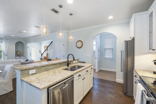 kitchen with decorative light fixtures, white cabinets, appliances with stainless steel finishes, and sink