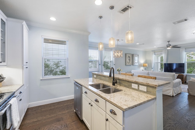 kitchen with stainless steel appliances, sink, dark hardwood / wood-style floors, white cabinetry, and hanging light fixtures