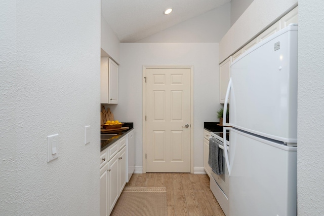 kitchen with white cabinets, light wood-type flooring, and white appliances