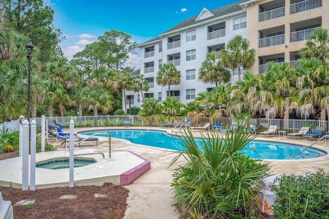 view of pool with a hot tub