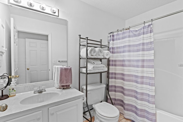 full bathroom featuring vanity, a textured ceiling, shower / bath combo with shower curtain, tile patterned flooring, and toilet