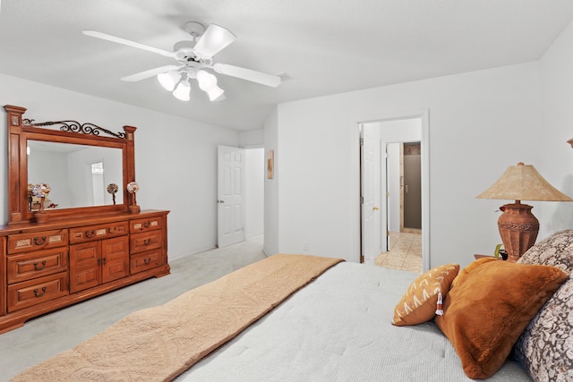 carpeted bedroom with connected bathroom and ceiling fan