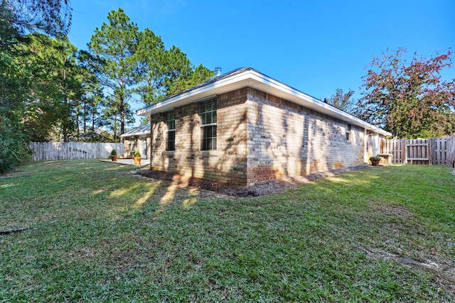 view of home's exterior with a yard