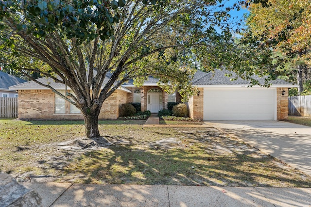 view of front of home with a front yard and a garage