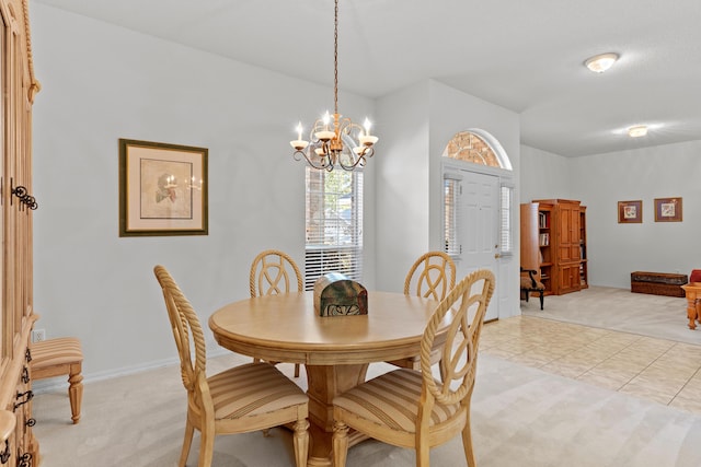 carpeted dining room with a chandelier