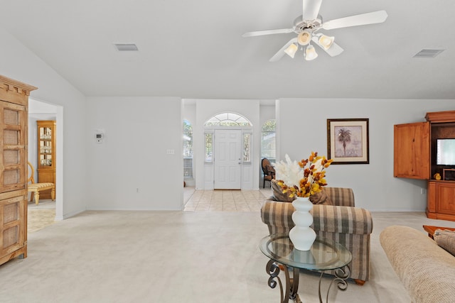 carpeted living room with ceiling fan and lofted ceiling