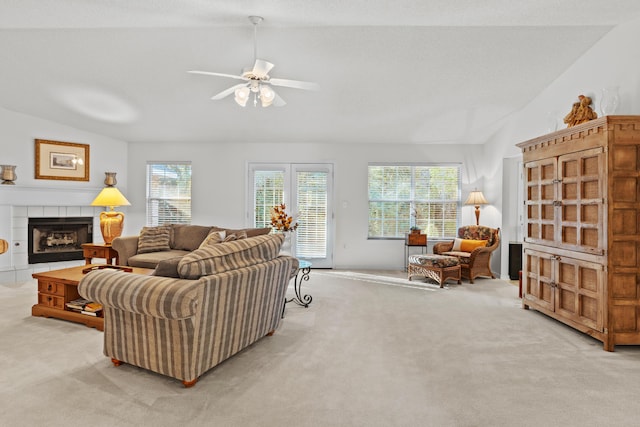 living room featuring light carpet, a healthy amount of sunlight, and lofted ceiling