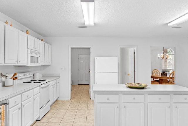 kitchen featuring white cabinetry, white appliances, and a textured ceiling