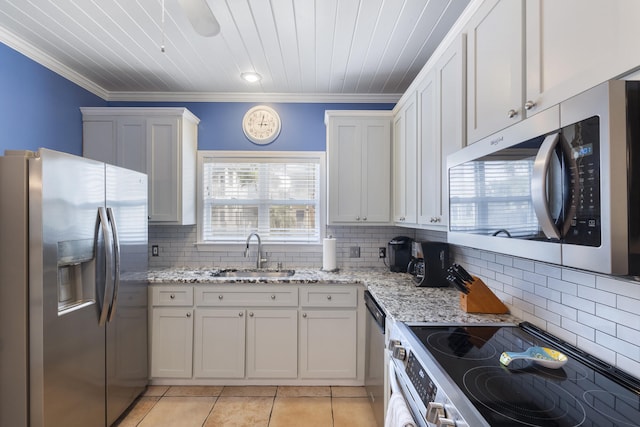 195 Emerald Dunes Cir, Santa Rosa Beach, FL 32459 - kitchen featuring stainless steel appliances, light tile patterned floors, crown molding, decorative backsplash, and light stone countertops