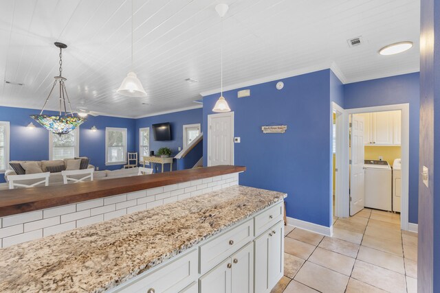 195 Emerald Dunes Cir, Santa Rosa Beach, FL 32459 - kitchen with separate washer and dryer, healthy amount of natural light, open floor plan, white cabinetry, and crown molding