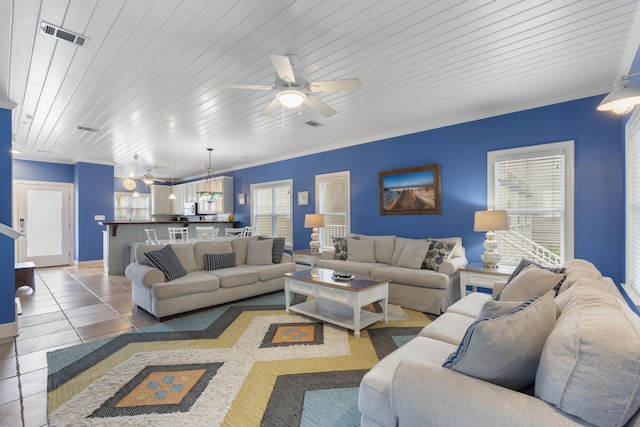 tiled living room with crown molding, ceiling fan, plenty of natural light, and wood ceiling