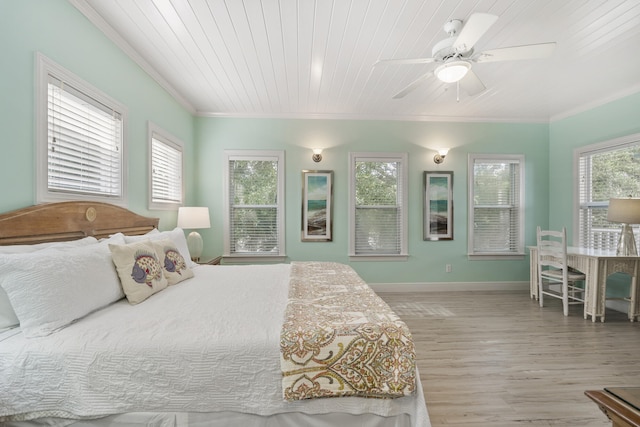 bedroom with multiple windows, ceiling fan, and light hardwood / wood-style floors