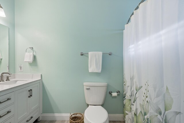 bathroom featuring vanity and toilet