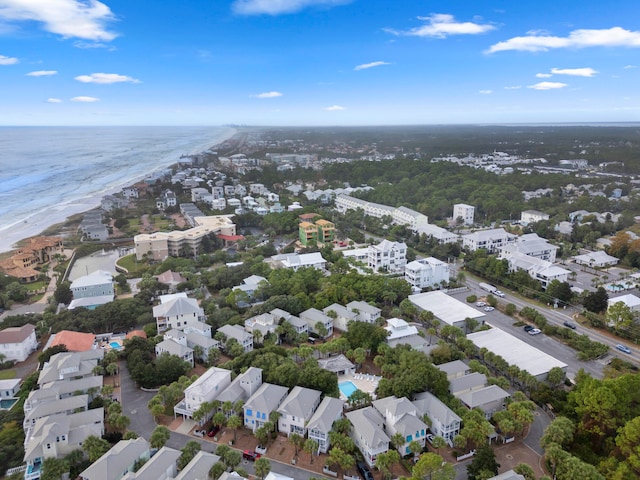 drone / aerial view with a beach view and a water view