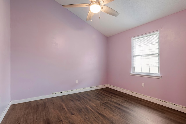 empty room featuring lofted ceiling, a textured ceiling, hardwood / wood-style flooring, and ceiling fan