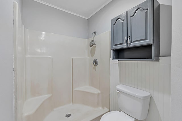 bathroom with crown molding, a shower, and toilet
