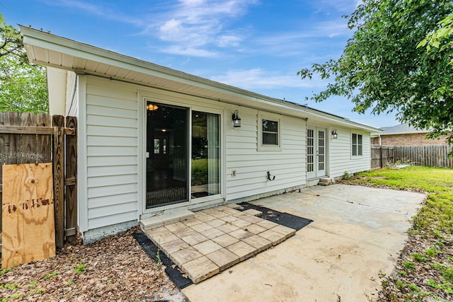 rear view of property featuring a patio area and a fenced backyard