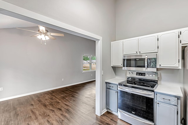 kitchen featuring stainless steel appliances, light countertops, a ceiling fan, dark wood-style flooring, and white cabinets