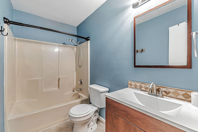 bathroom featuring toilet, baseboards, vanity, tile patterned floors, and washtub / shower combination