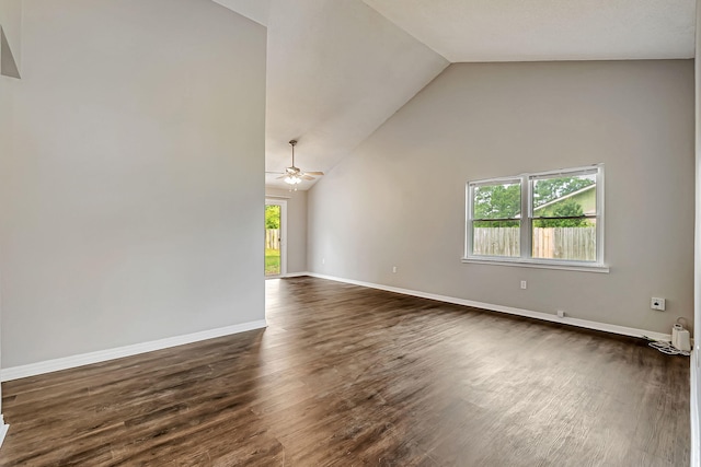 unfurnished living room with dark wood-style floors, ceiling fan, baseboards, and high vaulted ceiling