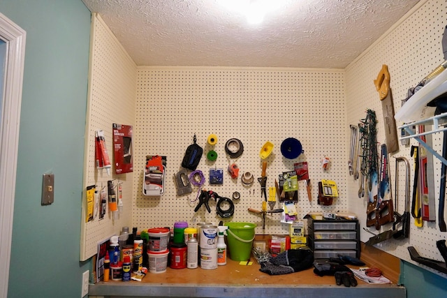 misc room featuring a workshop area and a textured ceiling