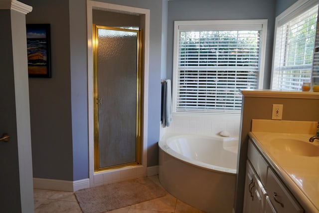 bathroom with vanity, tile patterned floors, and plus walk in shower