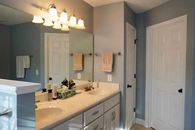 bathroom featuring vanity and a textured ceiling