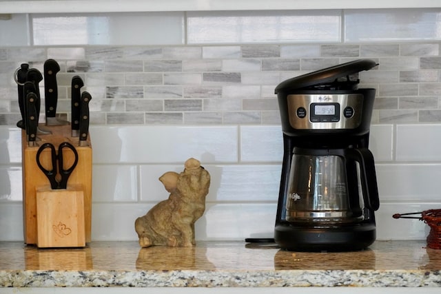 interior details featuring tasteful backsplash and light stone countertops