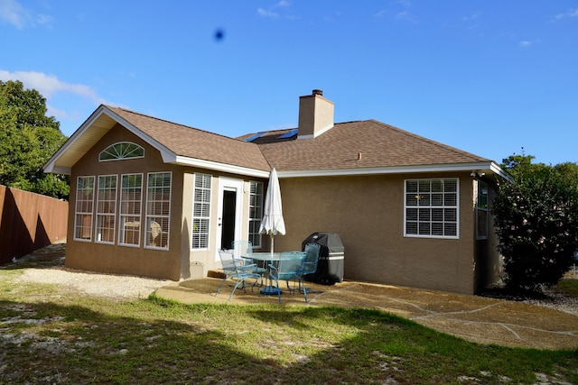 back of property with a patio and a yard