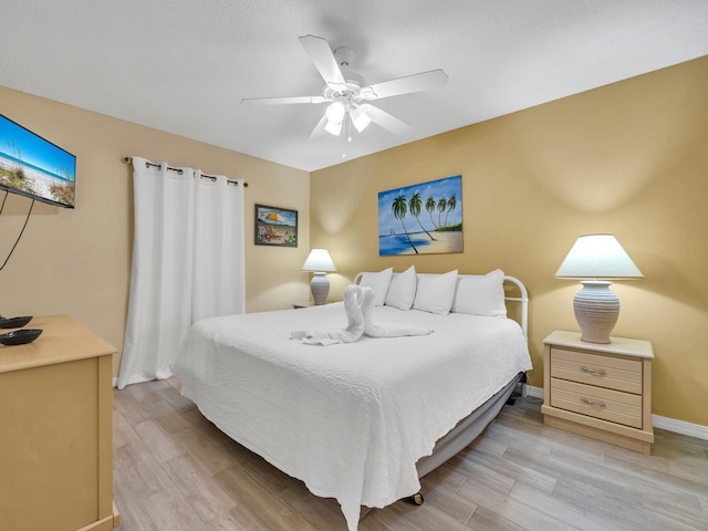 bedroom featuring ceiling fan and light wood-type flooring