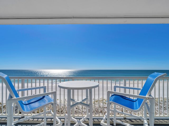 balcony with a view of the beach and a water view