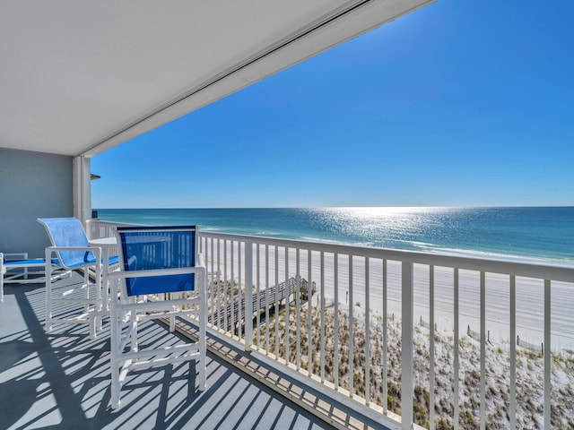 balcony with a view of the beach and a water view