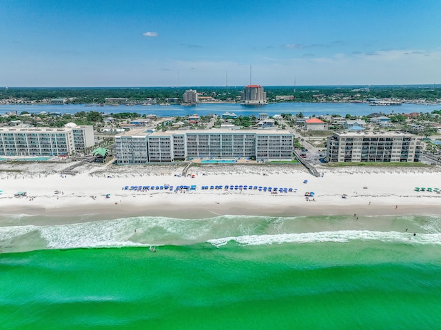 birds eye view of property featuring a beach view and a water view