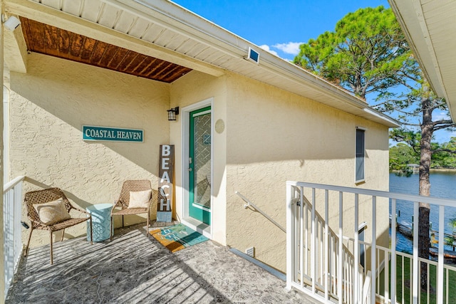 view of exterior entry with a water view