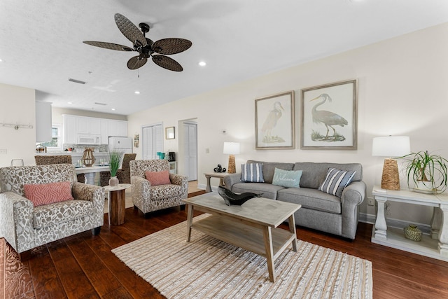 living room with dark hardwood / wood-style floors and ceiling fan