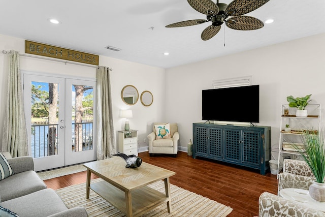 living room with ceiling fan, dark hardwood / wood-style floors, and french doors