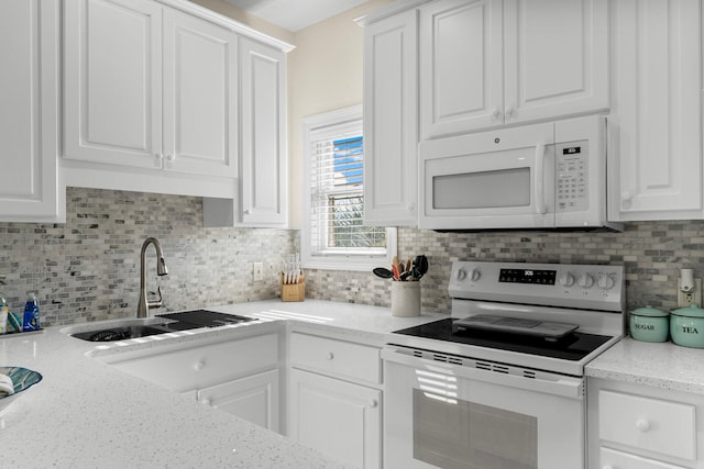 kitchen featuring white cabinets, sink, and white appliances