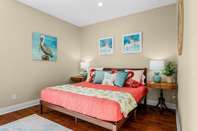 bedroom with dark hardwood / wood-style floors