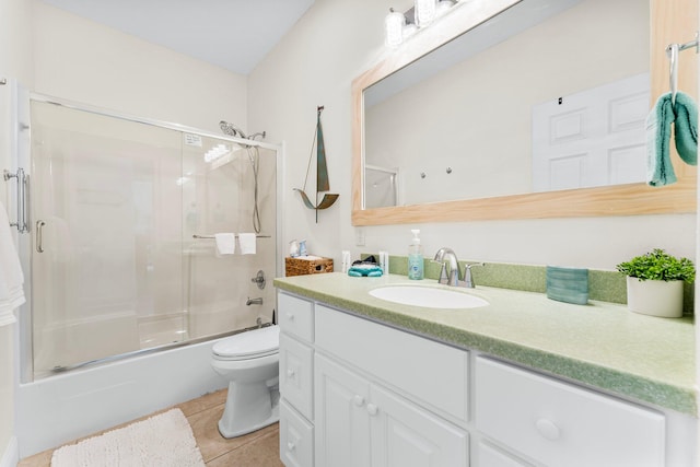 full bathroom with vanity, enclosed tub / shower combo, tile patterned flooring, and toilet