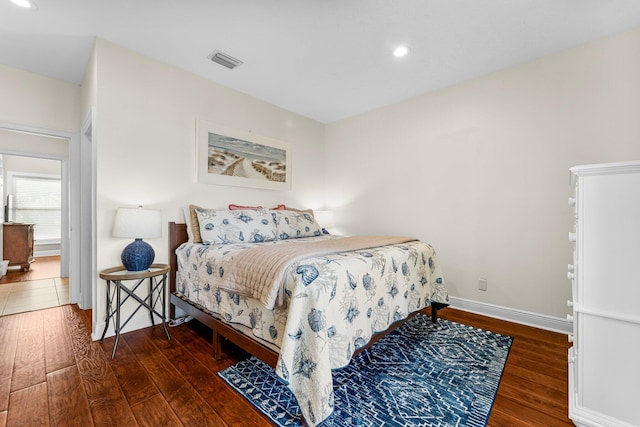 bedroom with dark hardwood / wood-style flooring